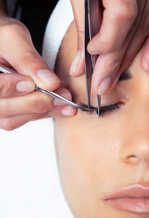 shot-cosmetologist-doing-eyelash-extension-procedure-woman-white-background