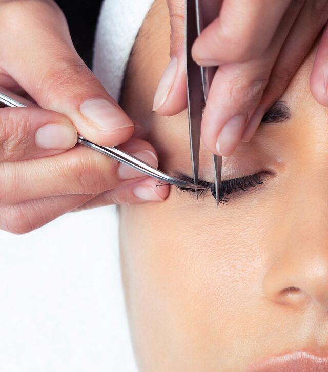 shot-cosmetologist-doing-eyelash-extension-procedure-woman-white-background
